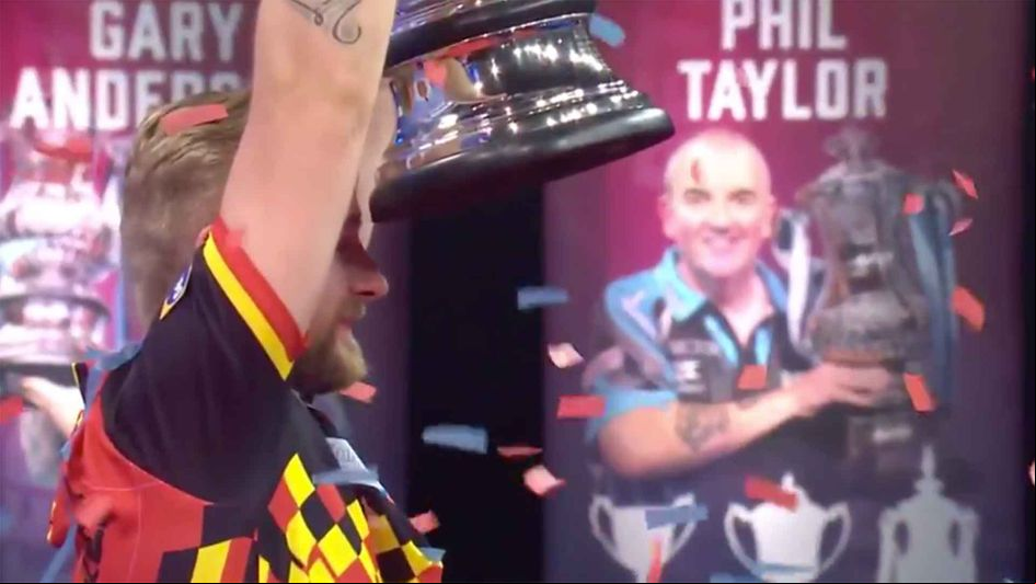 Dimitri Van den Bergh lifts the World Matchplay trophy