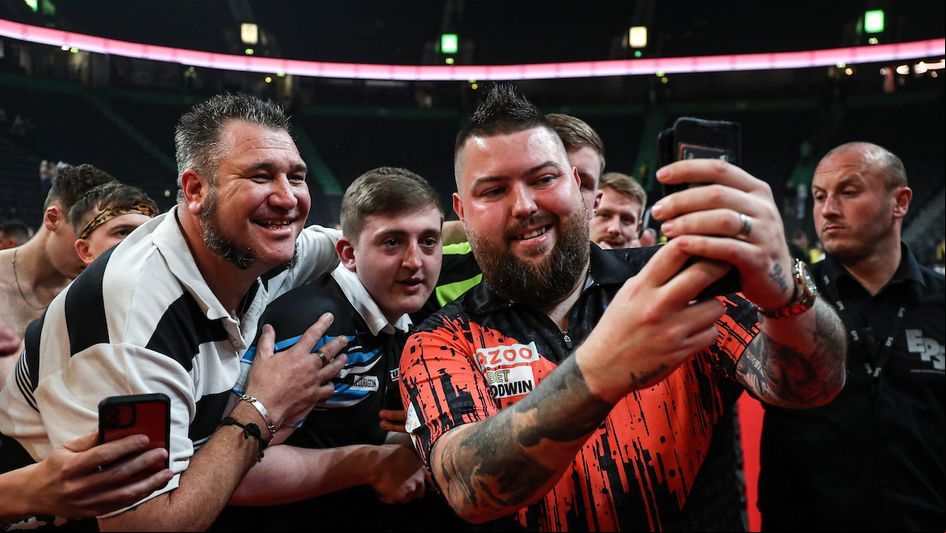Michael Smith celebrates with fans (Kieran Cleeves/PDC)