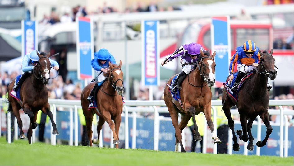 Minnie Hauk (purple and white silks) wins the Oaks at Epsom under Ryan Moore